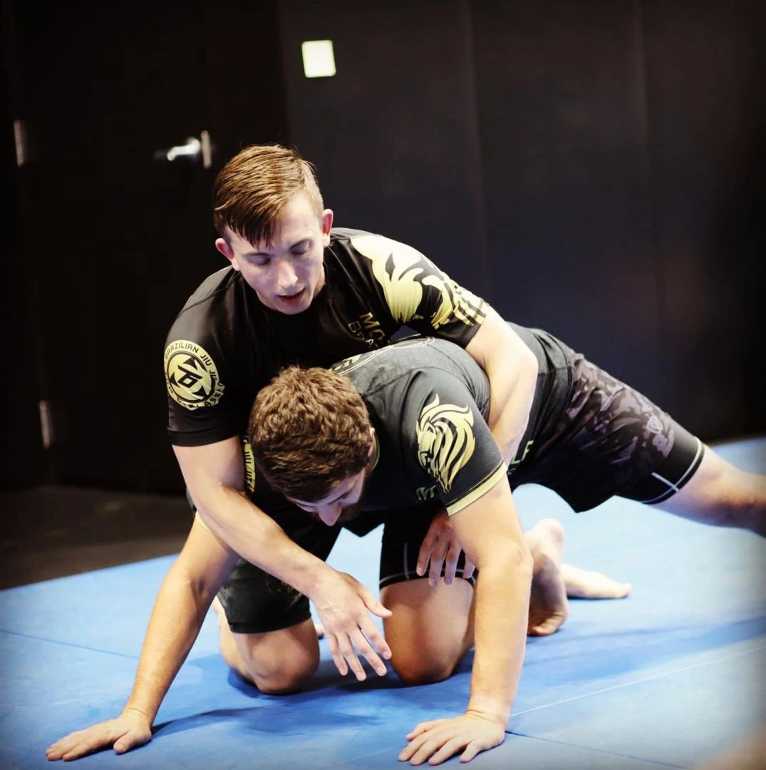 Adult Mooresville Brazilian Jiu-Jitsu student on the mat in branded gear — what your monthly membership gets you